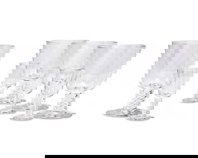 A suite of Steuben clear glass stemware: A suite of Steuben clear glass stemwareLate 20th/early 21st centuryEach etched to underside: SteubenComprising fourteen 5.75" water goblets and fourteen 3.875" cordials, each with air twist stems28 pi