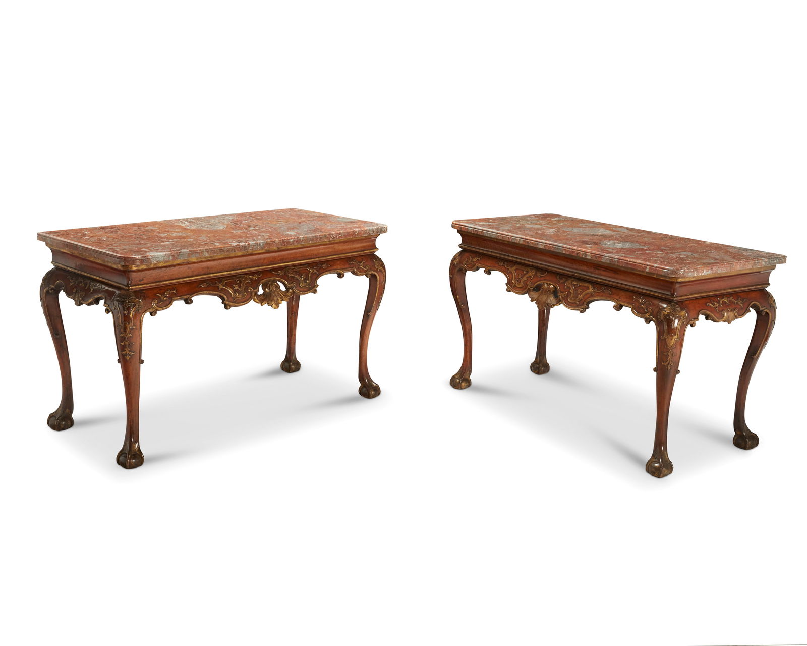 A pair of George III parcel-gilt walnut console tables: A pair of George III parcel-gilt walnut console tablesLate 18th century with later elementsEach surmounted by a mottled marble top, with gilt accents to the carving, raised on cabriole legs terminatin
