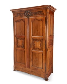 A Louis XV Provincial carved fruitwood armoire