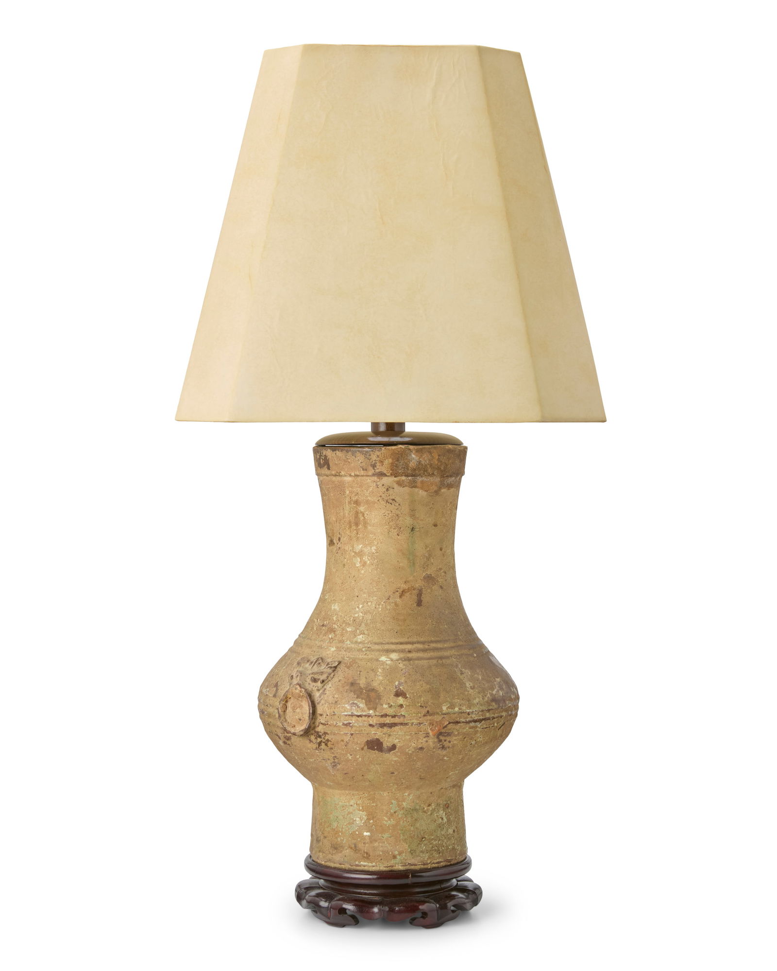 A Chinese stoneware jar converted lamp: A Chinese stoneware jar converted lampHan Dynasty (206 BCE-220 CE) with later elementsThe pottery jar mounted as a single-light table lamp on a carved wood base, surmounted by a paper shade, electrifi