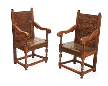 A pair of English carved oak wainscot armchairs