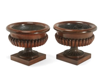 A matched pair of George IV carved mahogany wine coolers