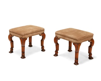 A pair of George I walnut and suede foot stools