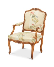 A Louis XV-style carved fruitwood fauteuil