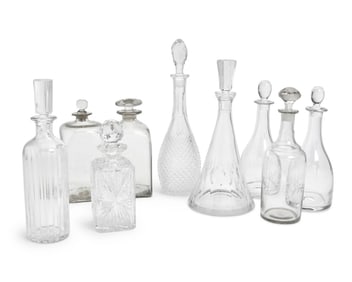A group of clear glass decanters