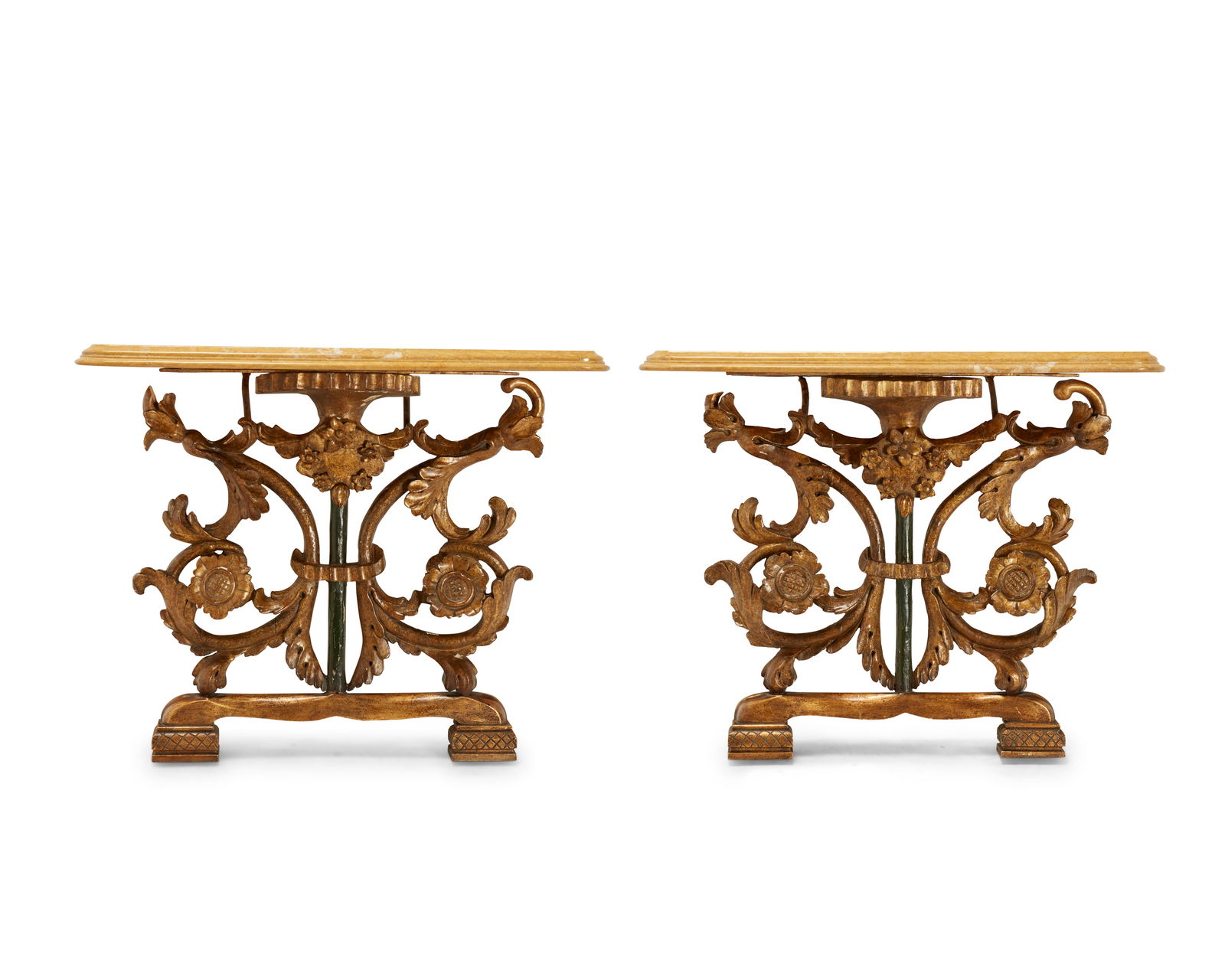 A pair of Continental carved giltwood and gesso console tables: A pair of Continental carved giltwood and gesso console tablesEarly/mid-19th century with antique elementsEach with carved gilt scrolls, acanthus leaves, and florets, and a green-painted central colum