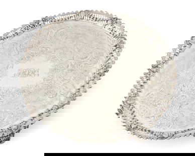 A George III sterling silver round footed tray: A George III sterling silver round footed tray1770Marked for sterling, for London, and date marked; maker's mark of John CarterThe pierced gallery rim with classical masks and urns joined by bellflowe
