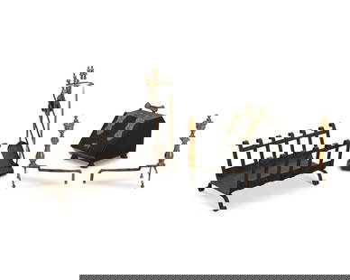 A group of fireplace tools: A group of fireplace tools19th/20th centuryComprising a wrought-iron firewood holder with scrolled sides and feet (12.5" H x 22" W x 18" D), a pair of turned brass and iron andirons (Each: 18" H x 8"