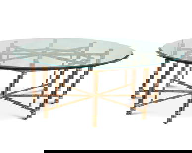 A McGuire large bamboo and glass dining table: A McGuire large bamboo and glass dining tableLate 20th centuryThe octagonal frame of bound bamboo construction surmounted by a round glass topOverall: 29" H x 83" Dia. Provenance:From the Collection o