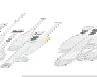 A group of glass decanters: A group of glass decantersLate 20th/early 21st centuryMost variously marked for makerComprising two De Martus silver plate-mounted glass decanters with stoppers (Taller: 12.5" H x 6.5" Dia.), a Saint-