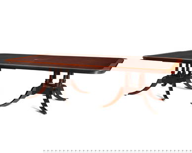 A George III-style mahogany and satinwood dining table: A George III-style mahogany and satinwood dining table20th centuryThe dining table raised on twin pedestals, each issuing four curvilinear fluted legs terminating in brass casters32" H x 120.5" W x 72