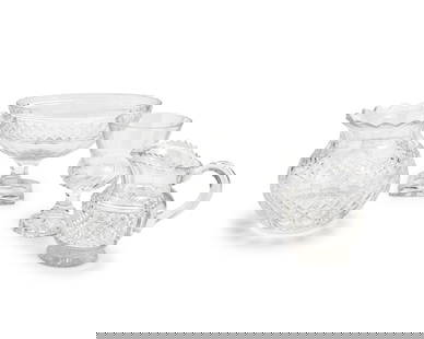 A group of cut glass vessels: A group of cut glass vesselsLate 20th/early 21st centuryOne marked for WaterfordComprising a Waterford bulbous vase, an urn-form cut glass oval bowl with rectangular foot, a footed pitcher, and a foot