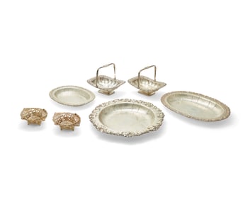 A group of silver-plated serving items