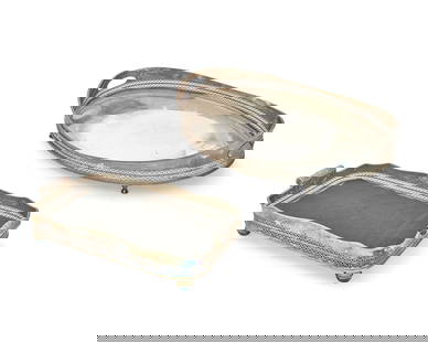 A group of metal serving trays: A group of metal serving trays20th centuryIncluding a gilt-metal oval tray, a gilt-metal oblong tray with scroll handles, and three large silver-plated galleried trays5 piecesLargest: 5.25" H x 30" W