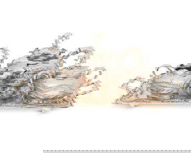 A Chinese Export silver tea service: A Chinese Export silver tea serviceLate 19th/early 20th centuryThree vessels marked: Cheong Shing; tray marked: KMS [Kwong Man Shing]Each with repousse dragons to body and bamboo-form handles and spou