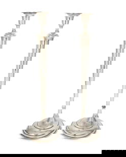 A pair of weighted sterling silver candlesticks: A pair of weighted sterling silver candlesticks20th centuryEach marked to underside: Sterling / R44The footed candlesticks, each with attenuated standard2 piecesEach: 20.25" H x 5.75" Dia.