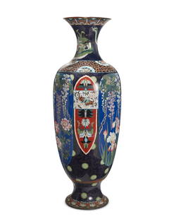 A monumental Japanese cloisonne vase: A monumental Japanese cloisonne vase20th centuryThe baluster-form enamel on copper vase decorated with alternating polychrome floral motifs and butterflies, with a swirled wave motif band to the shoul
