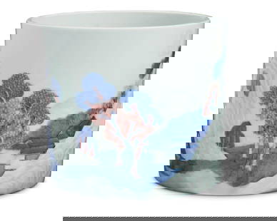 A Chinese blue and white and copper red porcelain brush pot: A Chinese blue and white and copper red porcelain brush potQing dynastyWith Ralph M. Chait Galleries sticker to undersideThe copper red and celadon porcelain with carved relief landscape decoration6.6