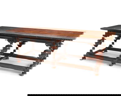 A Baroque-style carved walnut library table: A Baroque-style carved walnut library tableEarly 20th centuryThe wood table with an inlaid tabletop edge above cup and cover turned supports joined by a double box stretcher31.5" H x 96" W x 36" D