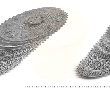 A Burmese sterling silver betel nut box: A Burmese sterling silver betel nut box20th centuryAppears unmarkedThe round vessel with elaborate chased and repousse scrolling vine motif surrounding cartouches of various animals, the lid with a ha