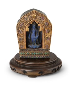 A Tibetan gilt-bronze ga'u shrine with a carved lapis figure of Siddhartha Gautama