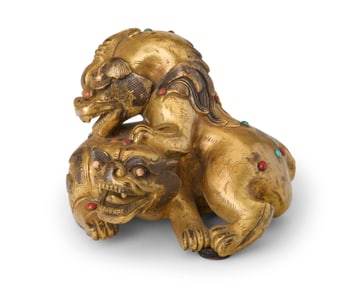 A Chinese gilt-bronze double guardian lion group