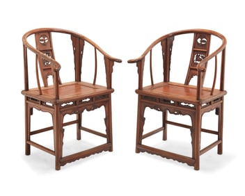 A pair of Chinese carved wood horseshoe chairs