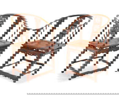 A pair of Chinese carved wood horseshoe chairs: A pair of Chinese carved wood horseshoe chairs20th centuryEach with rounded crest rail/armrests above a back splat with openwork figural motifs and openwork aprons with front panel accents to supports