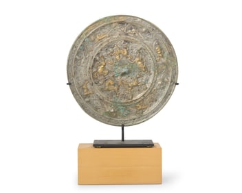 A Chinese silvered and gilt-bronze mirror