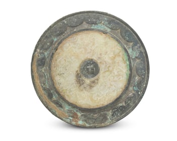 A Chinese bronze mirror with unusual jade inlay
