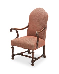 A Baroque-style carved wood open armchair