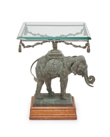 A patinated metal elephant-form side table