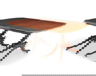 A Regency-style mahogany twin pedestal dining table: A Regency-style mahogany twin pedestal dining tableCirca 1930The rectangular cross-banded top over two pedestal supports, each with turned standard and four out-swept fluted legs ending in casters, ex