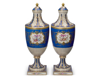 A pair of Dresden porcelain covered urns
