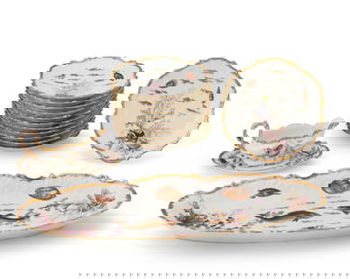 A Limoges porcelain fish service: A Limoges porcelain fish serviceEarly 20th centuryEach twice marked to underside: Limoges / FranceEach with transfer-printed sea life motifs and hand-gilt embellishments, comprising a serving platter