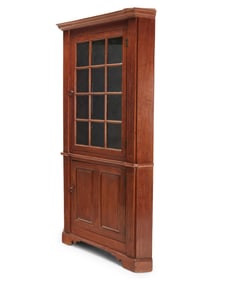 A Chippendale stained wood corner cupboard