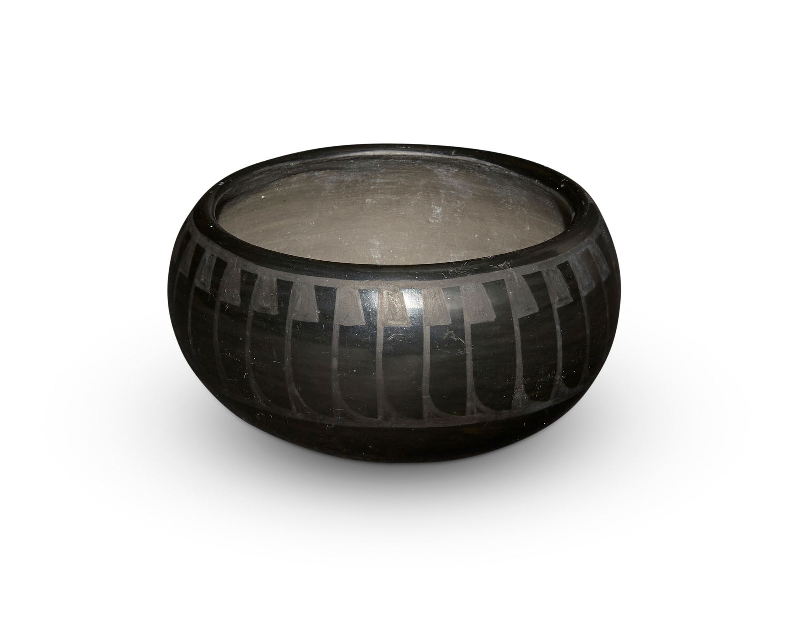 Crucita "Blue Corn" Calabaza (1921-1999, San Ildefonso Pueblo): Crucita "Blue Corn" Calabaza (1921-1999, San Ildefonso Pueblo)A blackware bowl, mid/late 20th centuryIncised to underside: Blue Corn / San Ildefonso PuebloA stone-polished black on black low rounded b