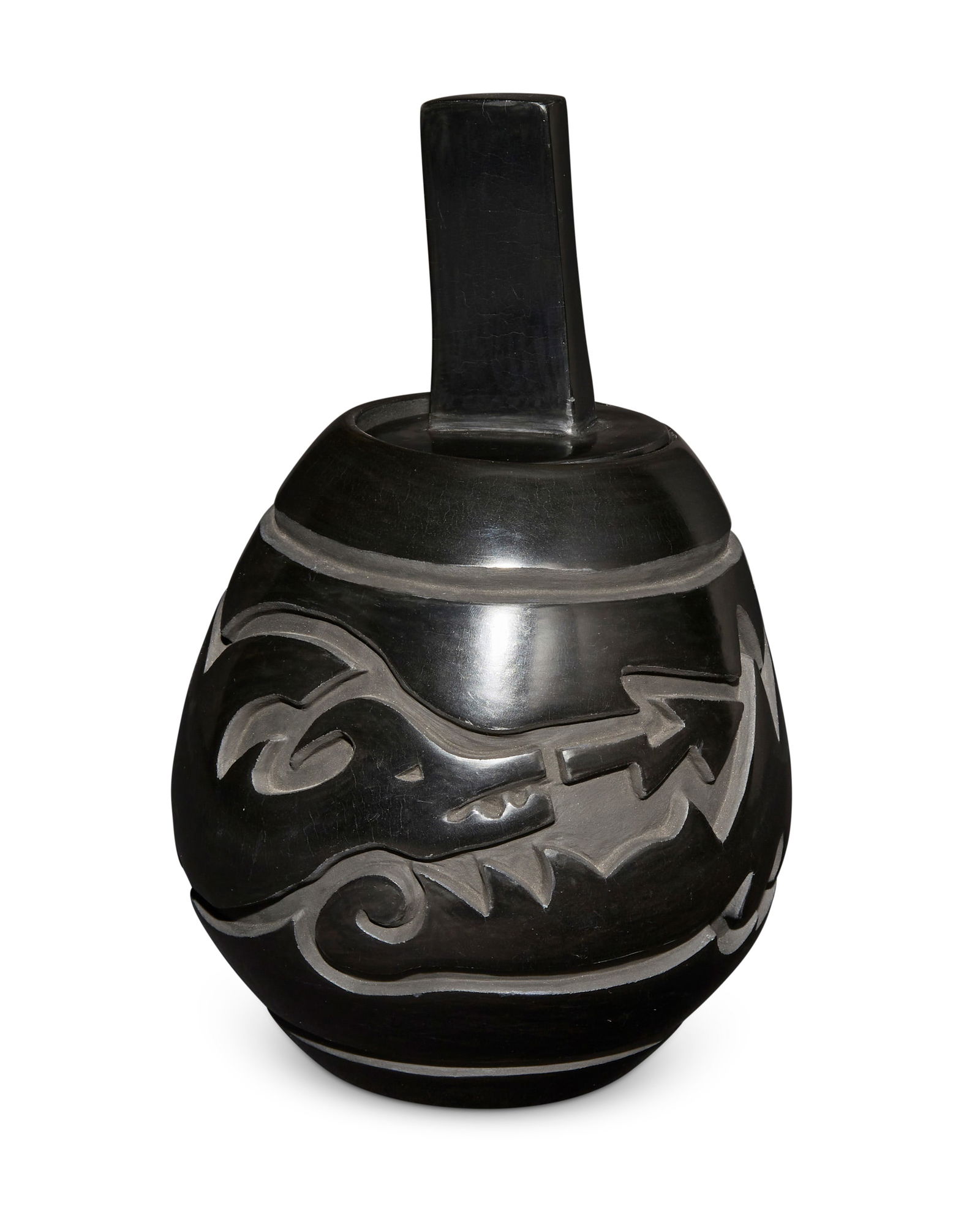 Jason Ebelacker (b. 1980, Santa Clara Pueblo): Jason Ebelacker (b. 1980, Santa Clara Pueblo)A Santa Clara blackware lidded pottery jar, late 20th/21st centuryWith incised signature to underside: J L Ebelacker / Santa Clara PuebloA tall jar with de