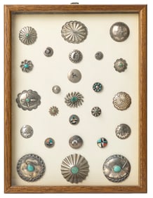 A framed collection of Navajo silver buttons
