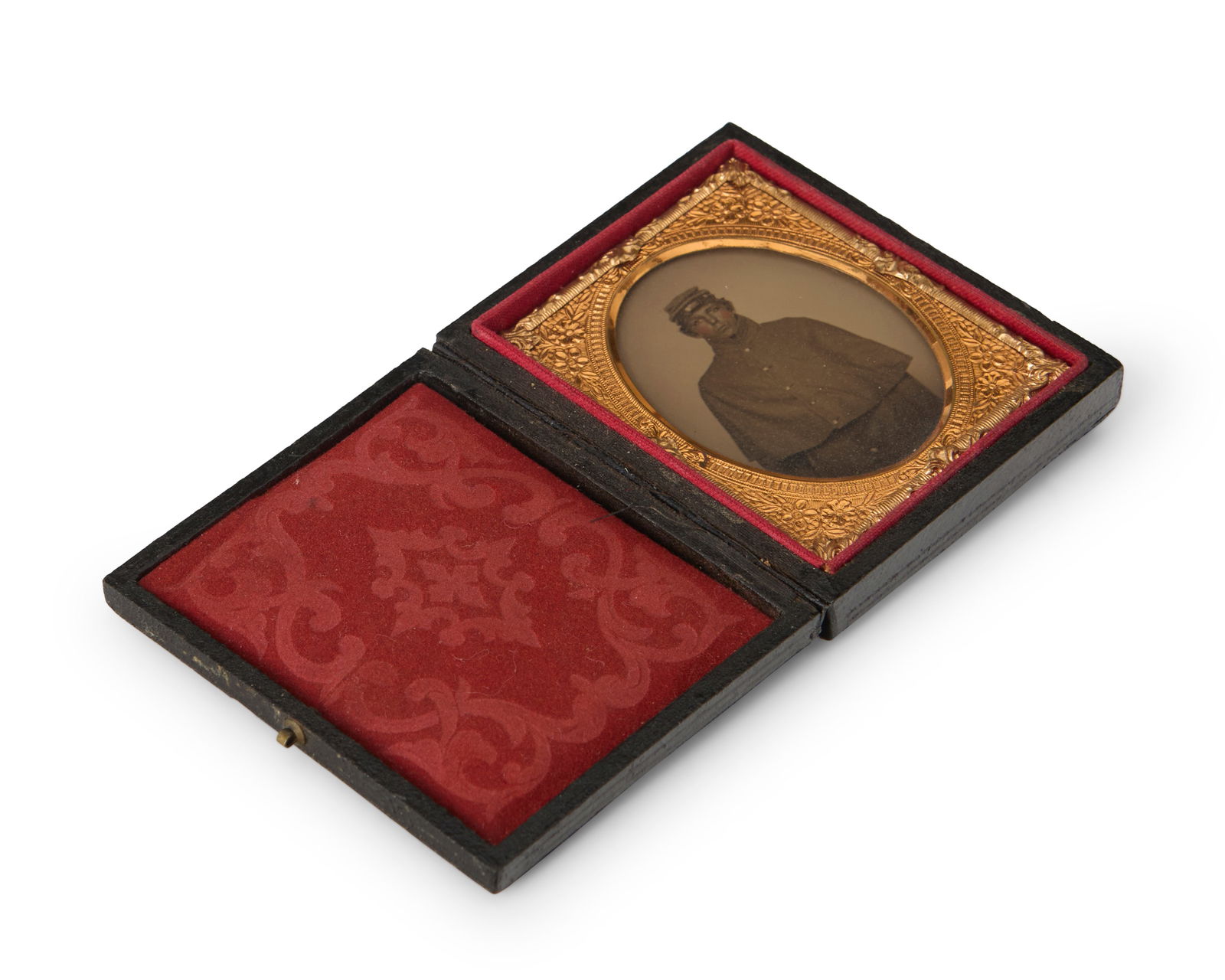 A Civil War era daguerreotype: A Civil War era daguerreotypeA daguerreotype depicting a uniformed soldier standing, with a chased gold-toned metal preserver within a red velvet-lined tooled leather caseSight: 2" H x 1.5" W