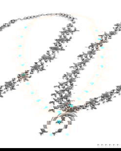 A Southwest sterling silver and turquoise squash blossom necklace: A Southwest sterling silver and turquoise squash blossom necklaceLate 20th centuryUnmarkedWith a central stone-set cast silver naja and twenty "fleur de lis" style blossoms, all suspended from a doubl