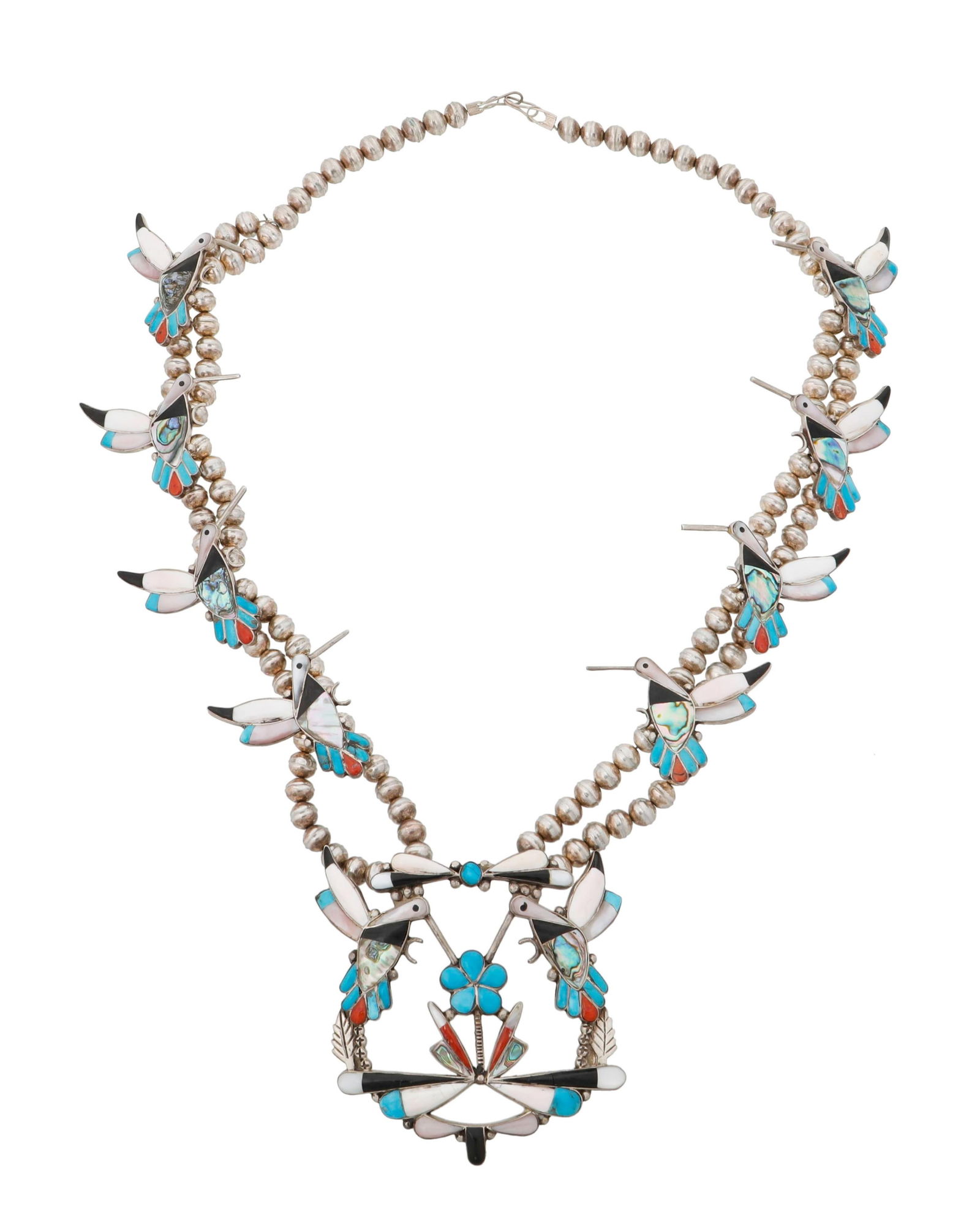 A Southwest silver and inlay hummingbird "squash blossom" necklace: A Southwest silver and inlay hummingbird "squash blossom" necklaceLate 20th centuryUnmarkedWith an elaborate sterling silver hummingbird "naja" and eight hummingbird "blossoms" in stone and shell inla