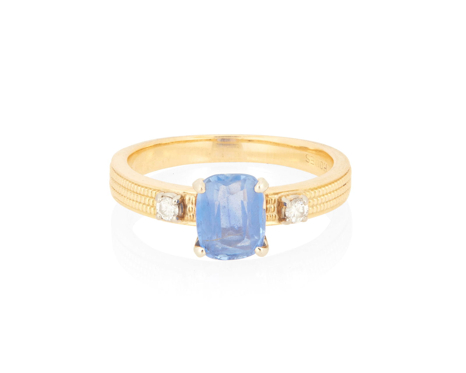 An 18K Gold and Sapphire Ring: An 18K Gold and Sapphire RingCentering a rectangular cushion-cut sapphire weighing approximately 1.25 carats accented by two round diamondsSize: 6 1/23.6 grams gross