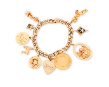A Gold Charm Bracelet Featuring Ruser Charms