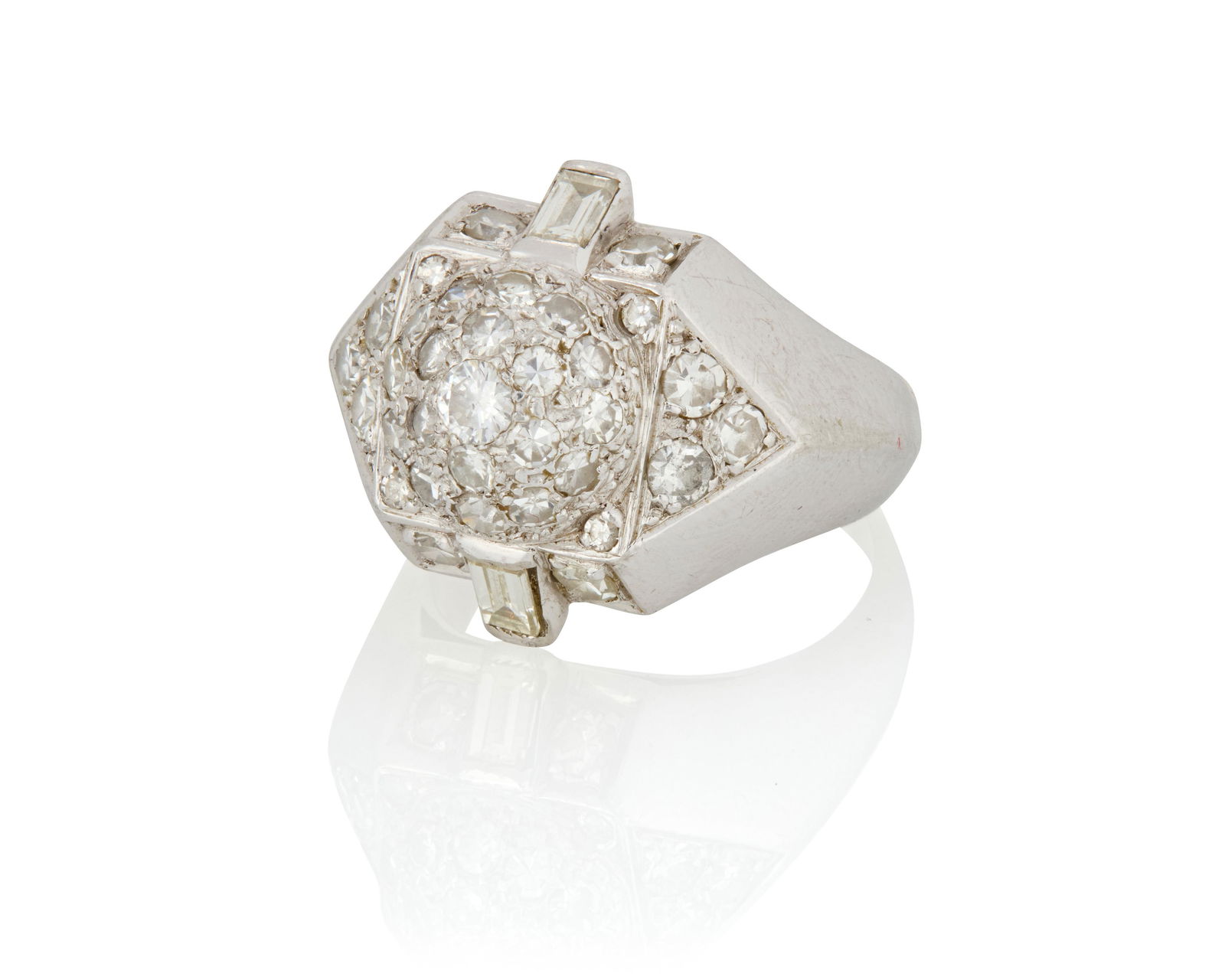 Suzanne Belperron: A Platinum and Diamond Ring: Suzanne Belperron: A Platinum and Diamond RingOf a geometric design featuring a domed center accented by single-cut and baguette diamonds weighing approximately 1.70 carats, finished with a knife-edge