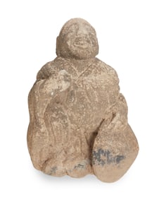 A Japanese carved stone seated deity figure