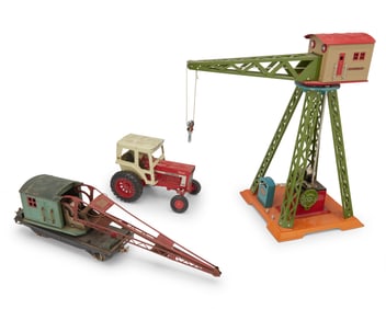A group of toys including a tractor and two cranes