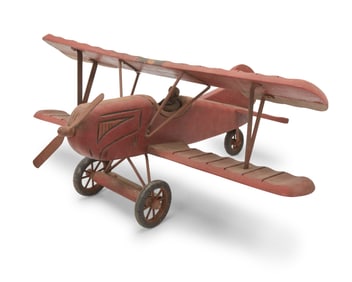 A carved wood model biplane
