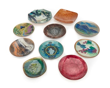 A group of enameled metal art plates