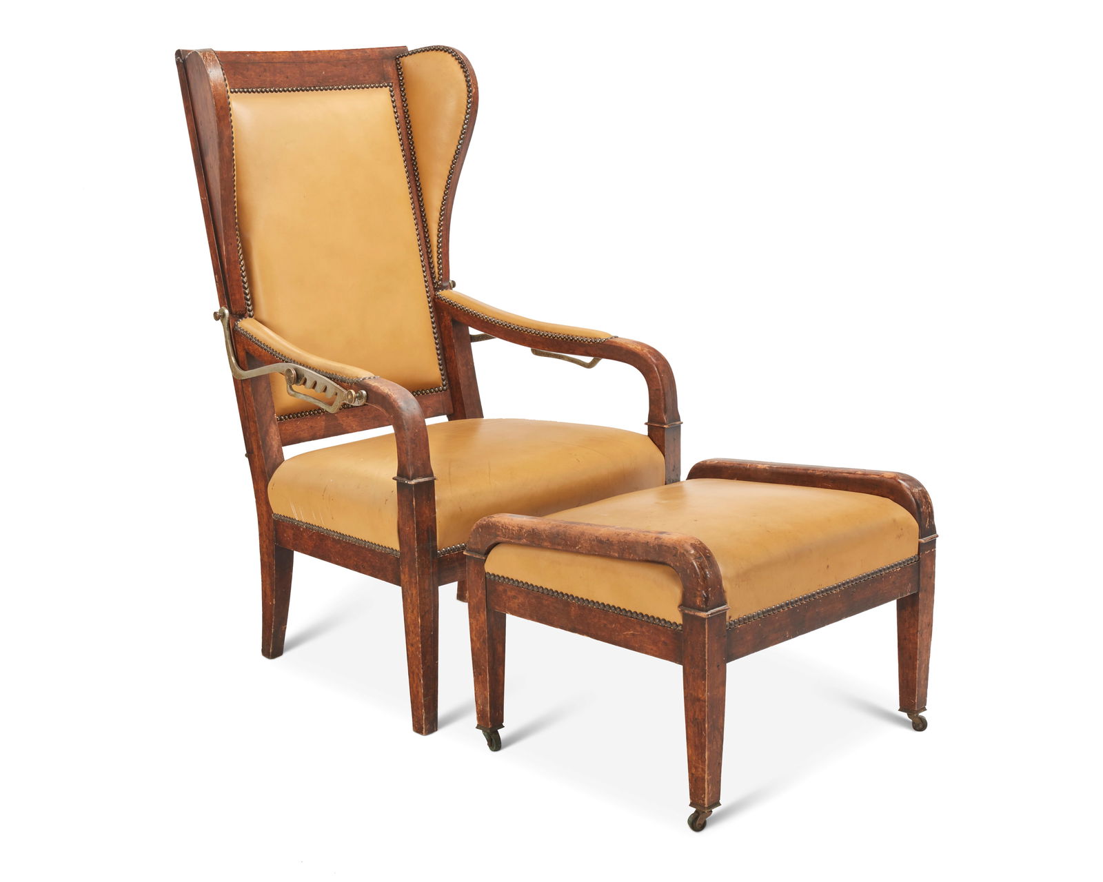 A wingback reclining chair and ottoman: A wingback reclining chair and ottomanEarly 20th centuryThe wood chair with leather upholstery and brass tacking, featuring a reclining mechanism engaged at armrests with five settings, including conf